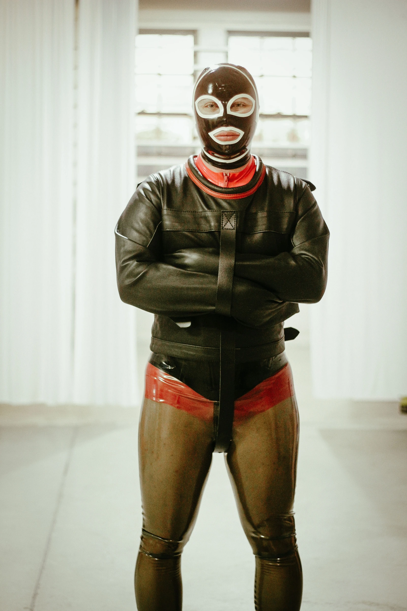 Full-length front portrait of a Leather Posey Replica with crossed sleeves.